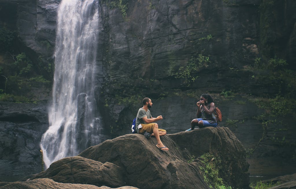 Image Gallery 6 A serene moment captured by a waterfall in India with a couple enjoying nature's beauty together.